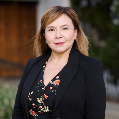 Rosa Calderón, Administrative Specialist, stands in front of Sacred Heart Chapel